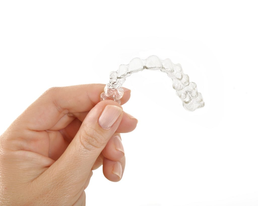 person holding an invisalign
