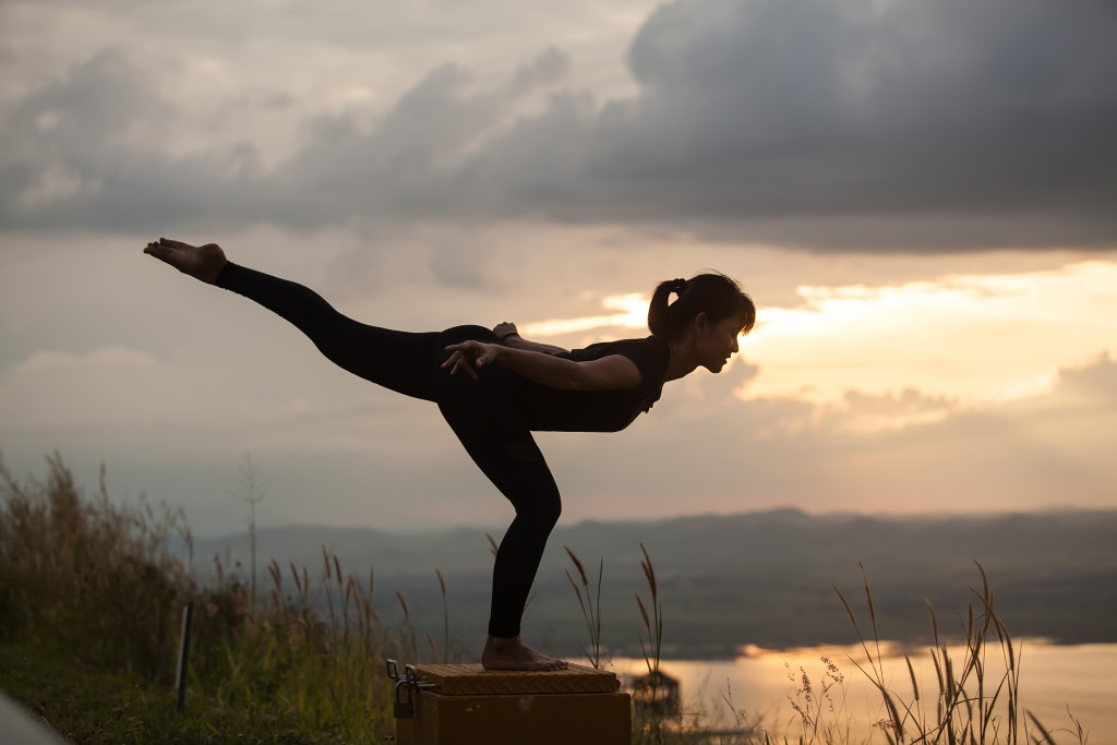 a woman doing yoga pose outdoor
