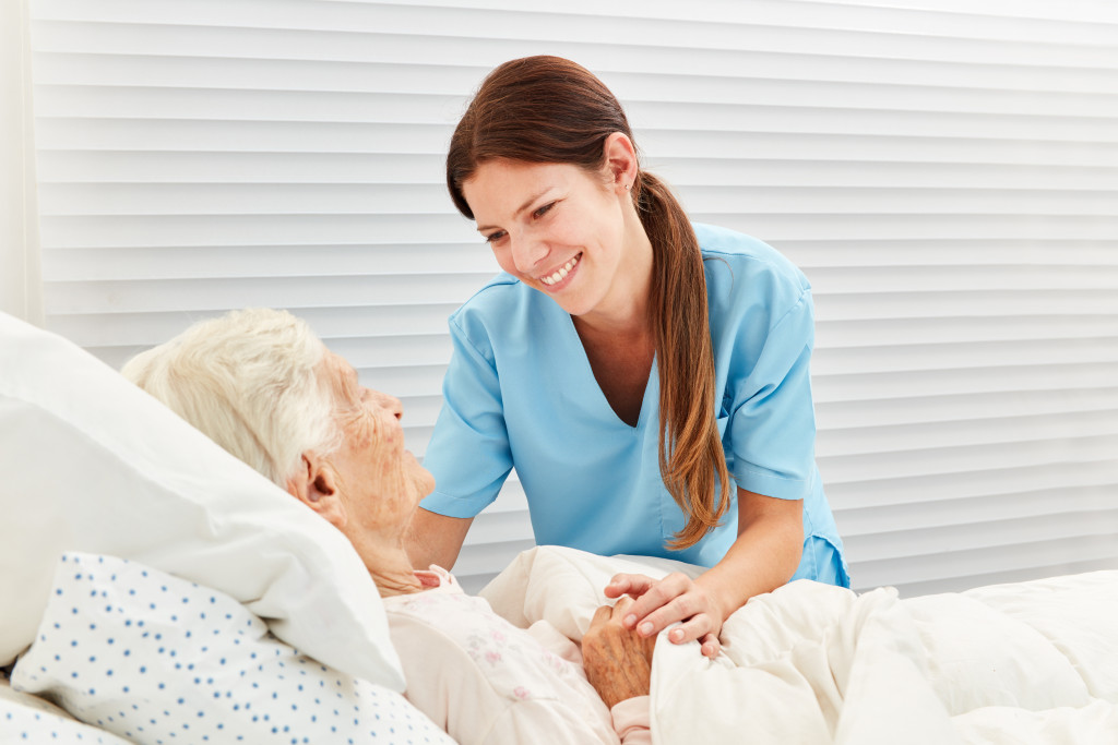 A hospice nurse caring for a senior woman